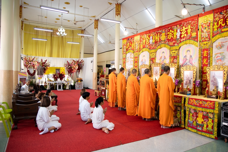 ถ่ายภาพงานศพ ช่างภาพถ่ายบรรยากาศพิธีในวัด มีพระสงฆ์และญาติโยมนั่งฟังธรรม