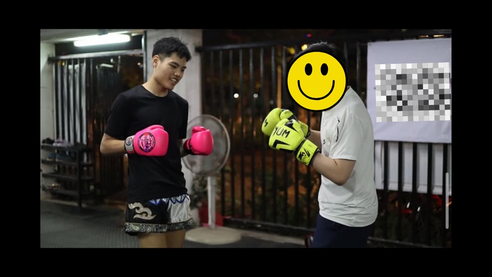 เทรนเนอร์ส่วนตัว กรุงเทพฯ กำลังสอนมวยให้กับลูกค้า สวมนวมชกมวยสีชมพูและสีเขียว หา personal trainer